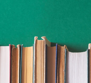 line up of book fore-edges against a green backdrop