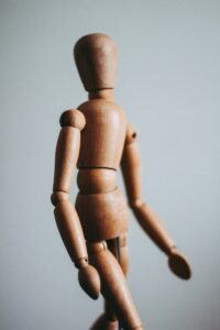 close-up photo of brown wooden doll