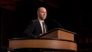 Jared Bryant standing at chapel podium