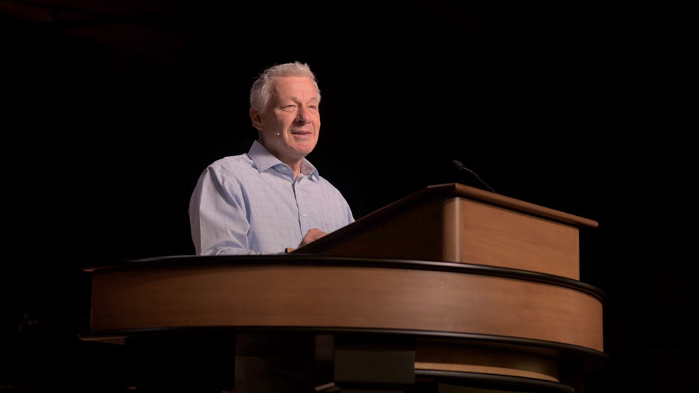 Matt McAlack standing at chapel podium