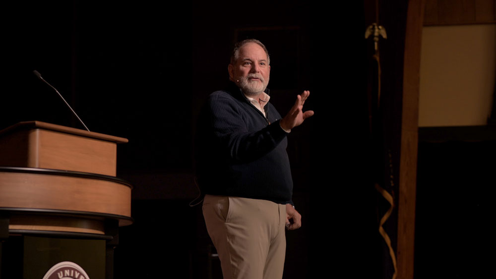 Todd J. Williams standing on chapel stage