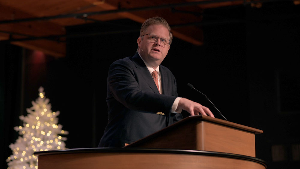 Jonathan Master standing at chapel podium