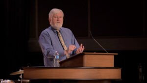 Bryan Maier standing behind chapel podium