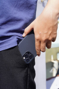 photo of hand putting a cell phone into a front pant pocket