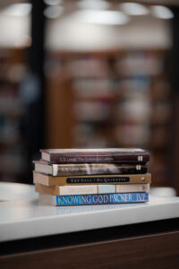 a stack of books on a counter in a library