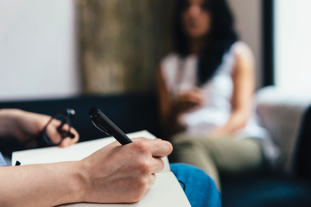 a woman sitting at a counseling session