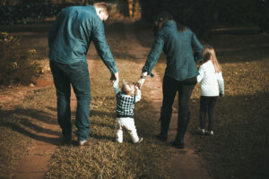 young family walking on a dirt road