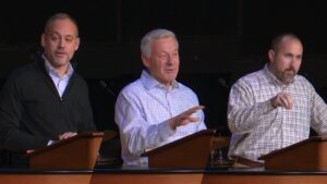 split screen photo of Dr. Kevin McFadden, Dr. Matt McAlack, and Dr. Bryan Murawski standing behind chapel podium
