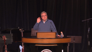 Dr. Matthew Miller standing behind chapel podium