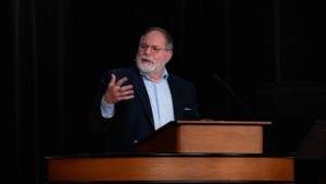 Todd Williams standing behind chapel podium