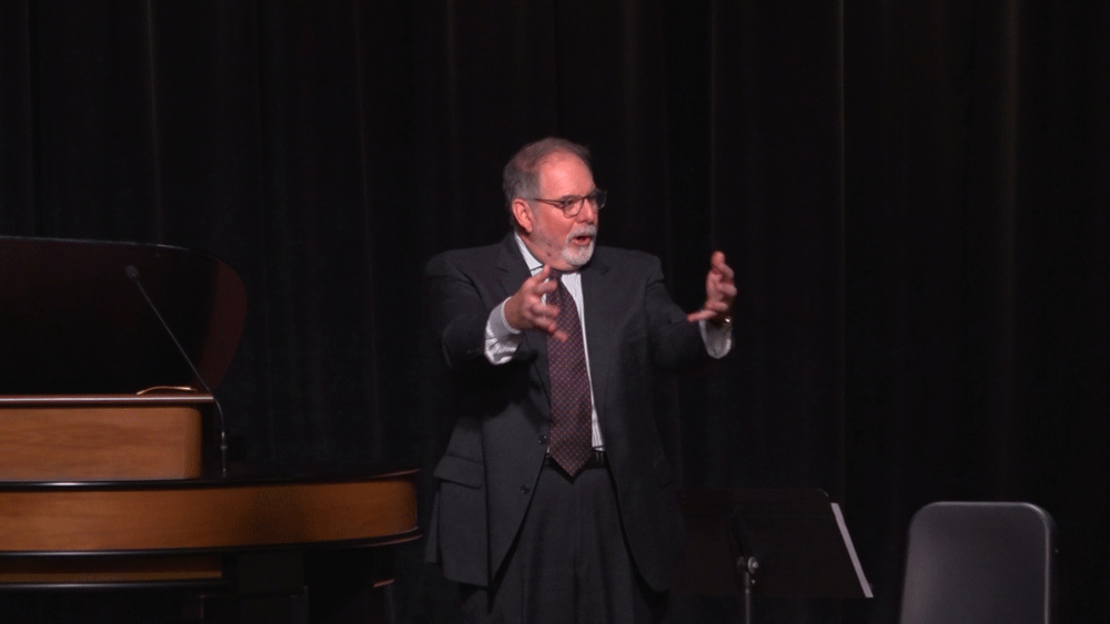 Todd Williams standing next to chapel podium