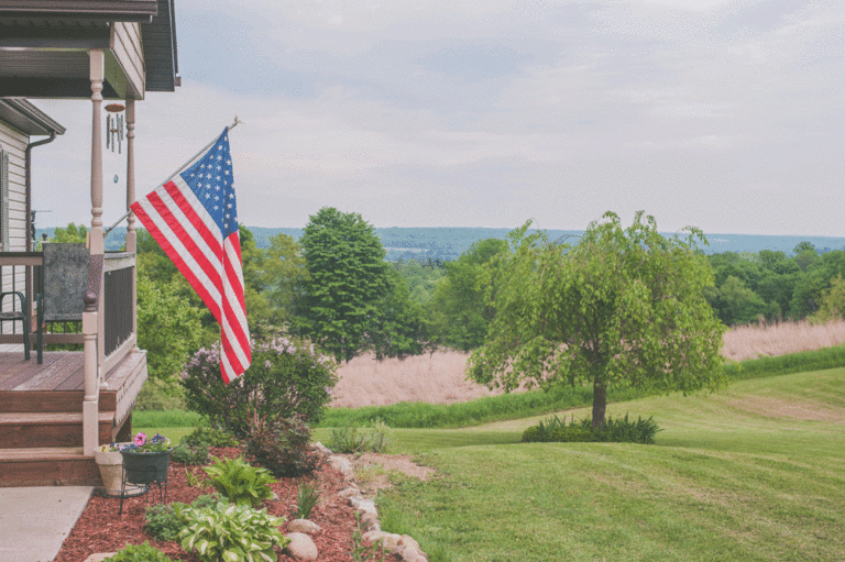 United States flag hanging from a front porch
