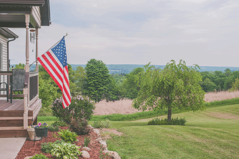 United States flag hanging from a front porch