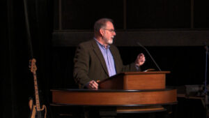 Todd Williams standing behind chapel podium