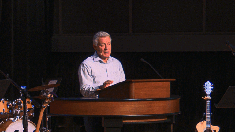 Matt McAlack behind chapel podium