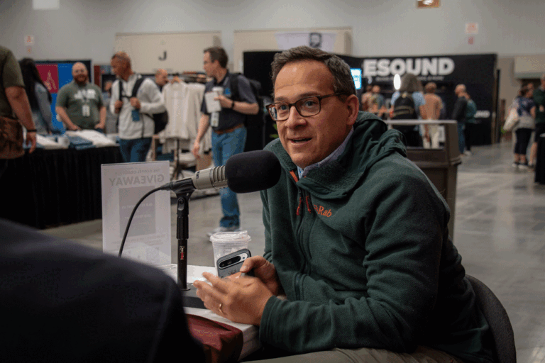 Michael Keller sitting at a podcast mic in the TGC conference center