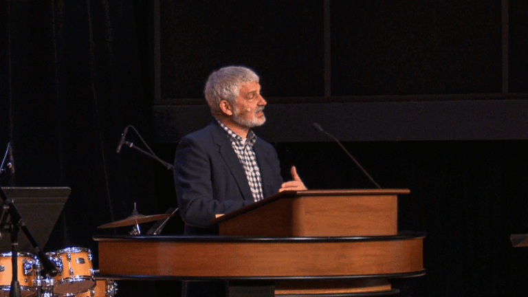 Pastor Tim Bouffard standing behind chapel podium
