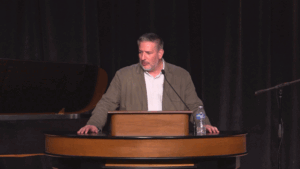 Jared Wilson standing behind chapel podium