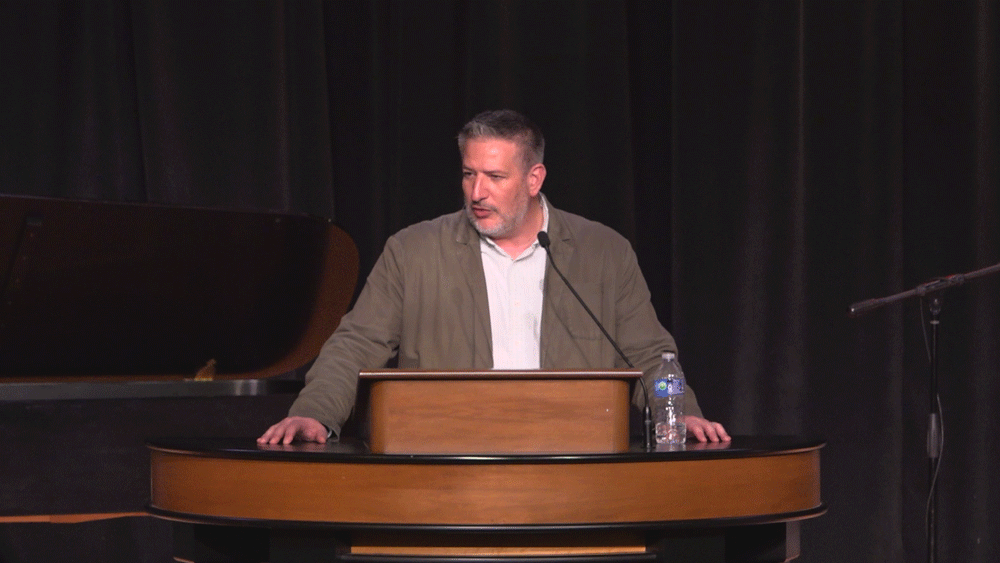 Jared Wilson standing behind chapel podium