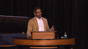 Robin John standing behind chapel podium
