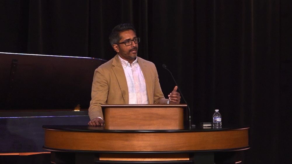 Robin John standing behind chapel podium