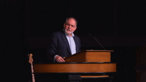 Dr. Williams behind chapel podium
