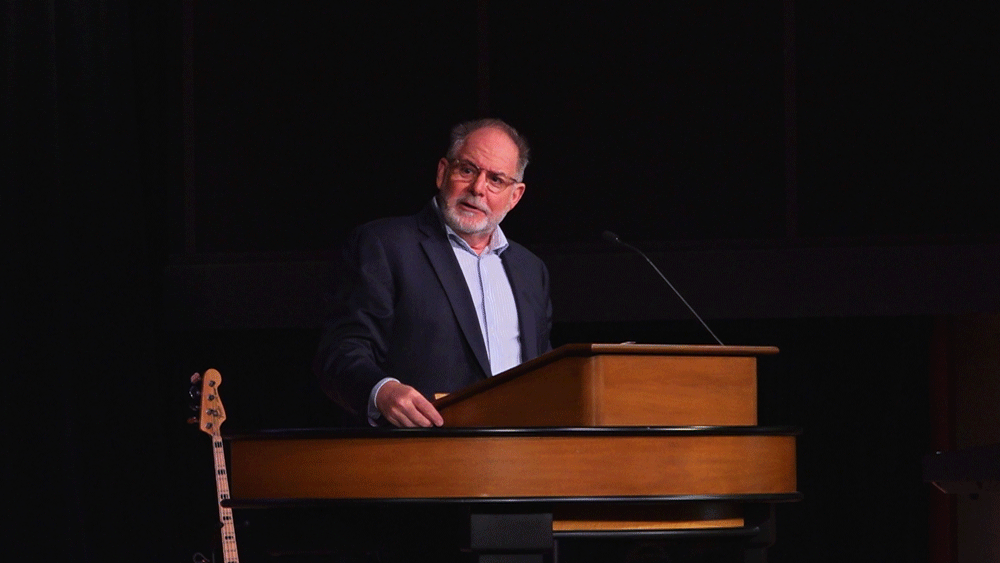Dr. Williams behind chapel podium