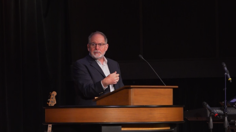 Todd Williams standing behind chapel podium