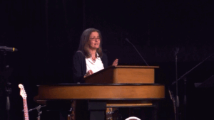 Dawn Williams standing behind chapel podium