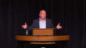 Don Lough standing behind chapel podium