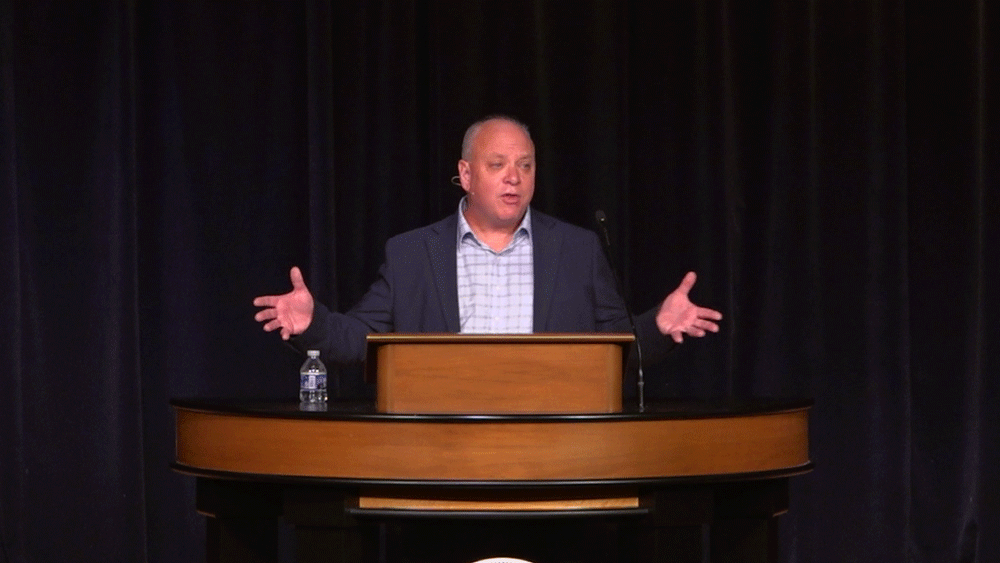 Don Lough standing behind chapel podium
