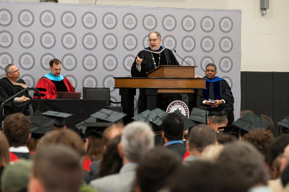 Dr. Williams standing on Commencement Stage behind podium