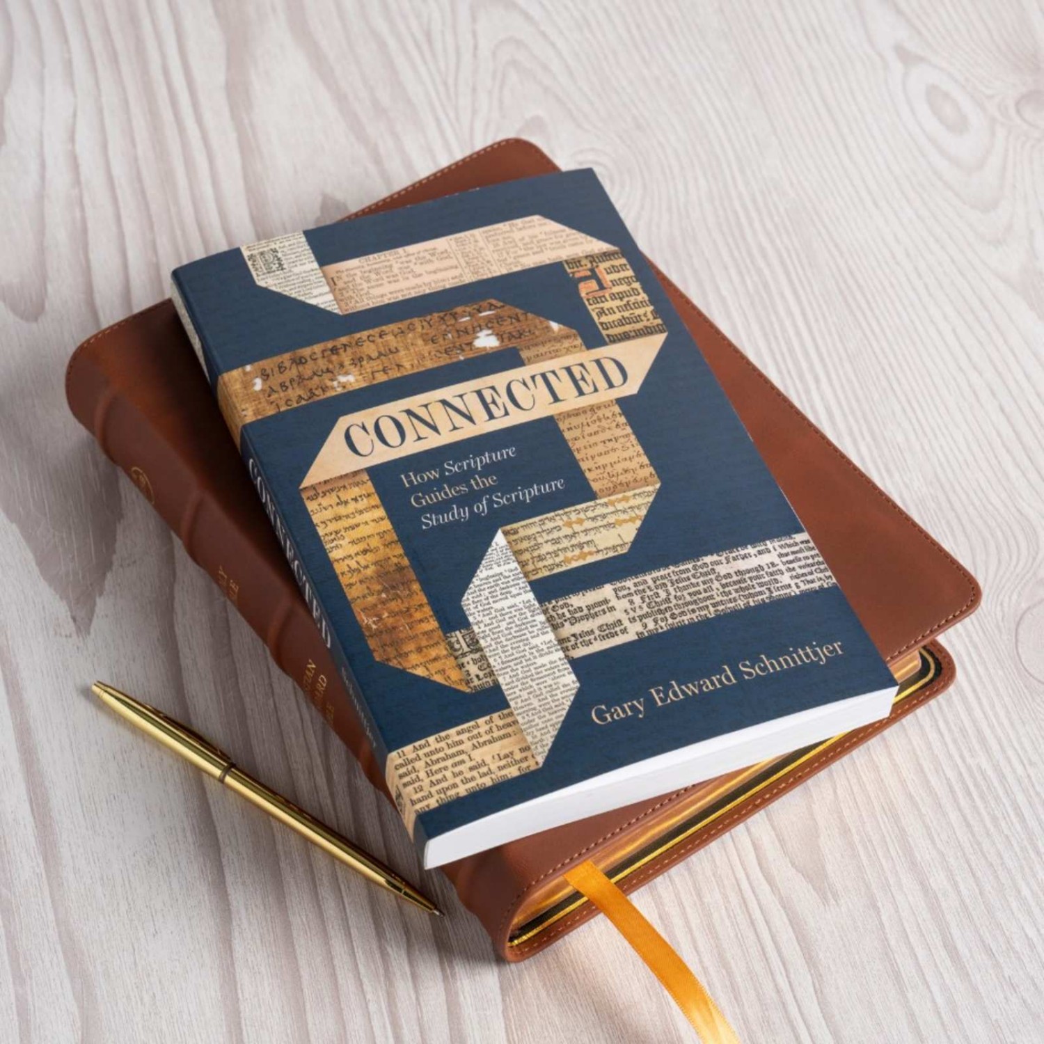 photo of Connected book laying on top of a Bible next to a pen on a table (pc: B&H Academic)