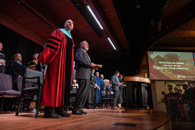 Dr. Williams standing next to Dr. Porcella on chapel stage