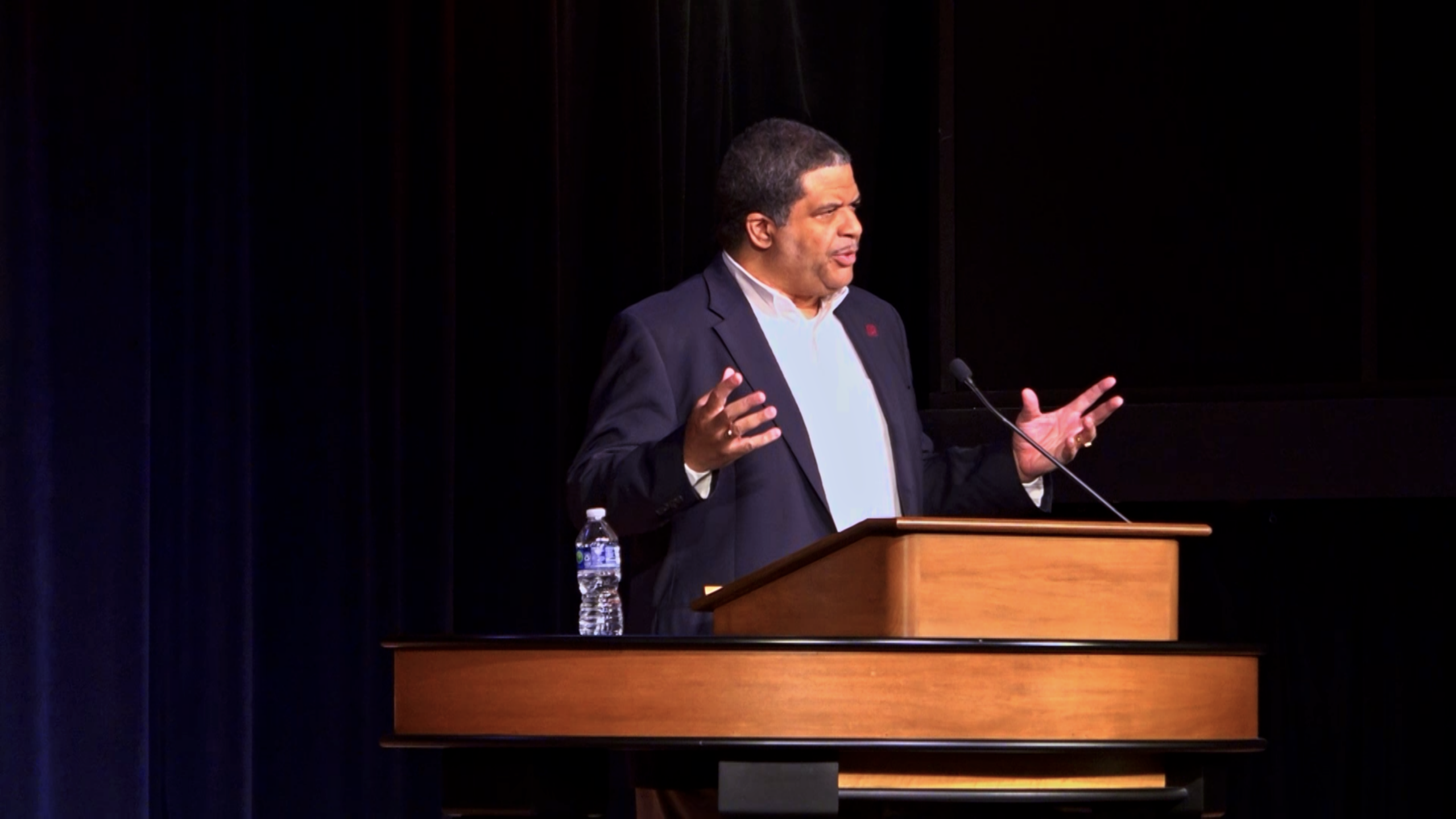 Dr. Keith Plummer speaking behind chapel podium