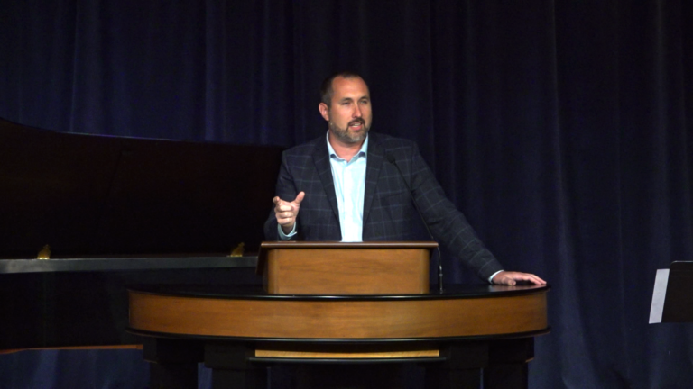 Bryan Murawski standing behind chapel podium