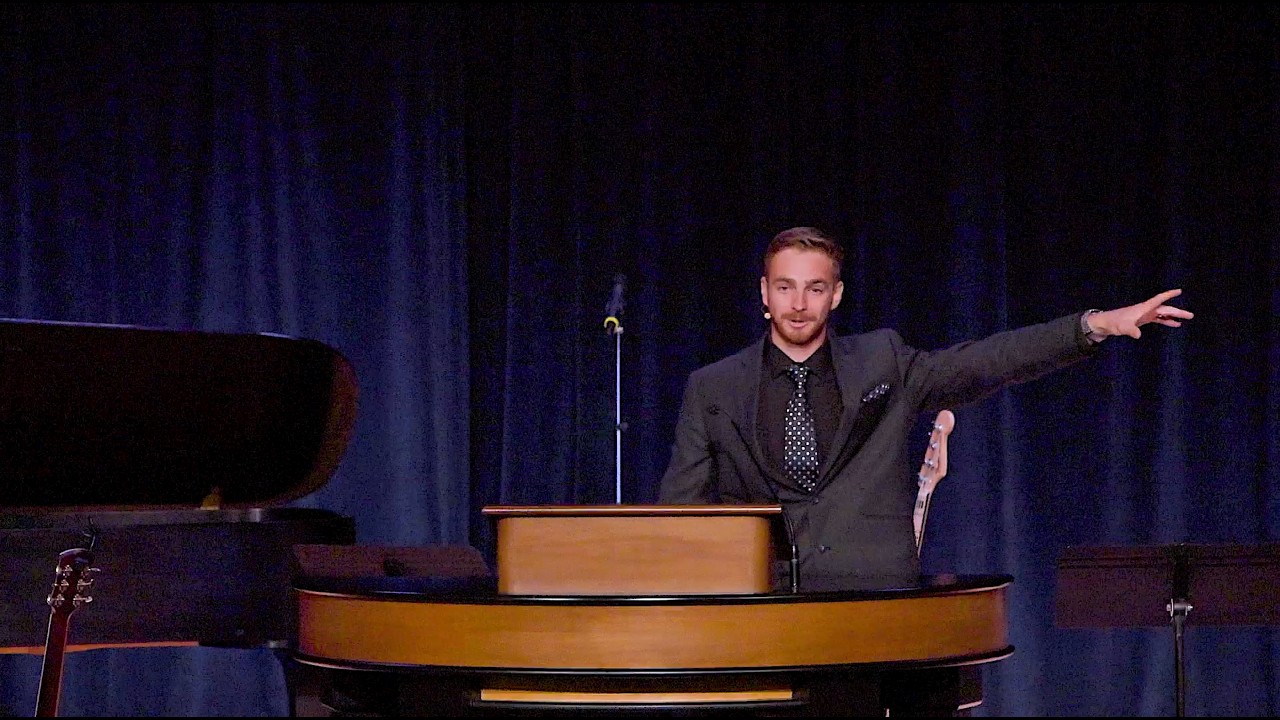 Jesse Stokes standing behind chapel podium