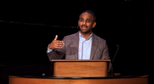 Siby Varghese standing behind chapel podium